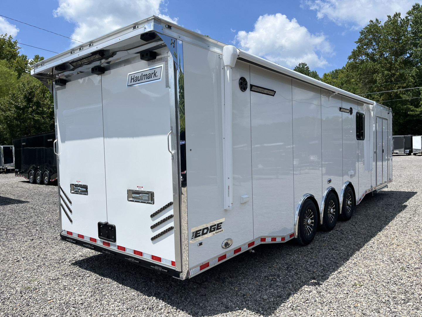 New 2026 Haulmark 34 Bathoom Race Trailer, Air Prep PKG, Awning, Polycor, Insulated, Window, 54" ALX Slide Out Step, A/C + Heat