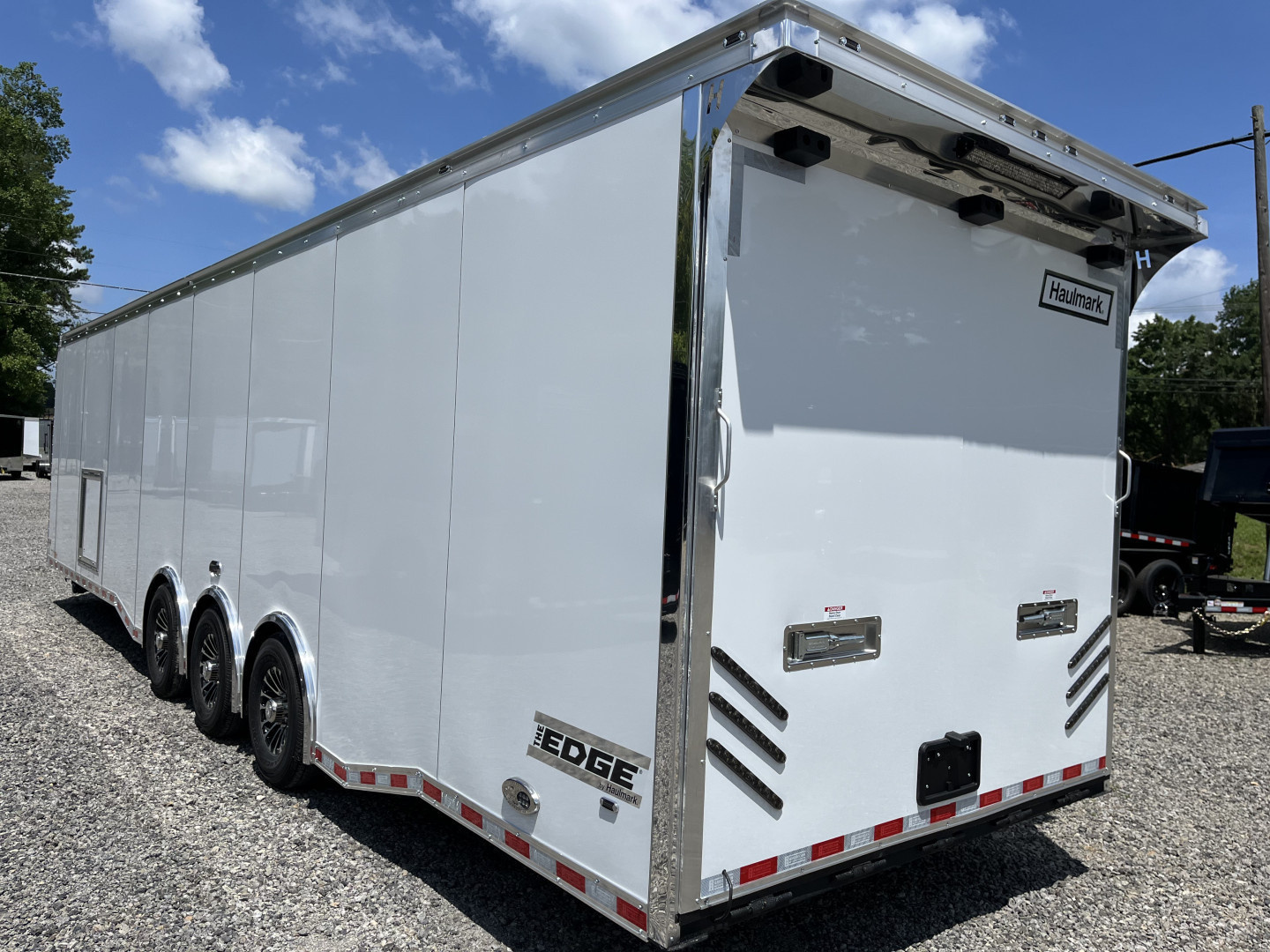 New 2026 Haulmark 34 Bathoom Race Trailer, Air Prep PKG, Awning, Polycor, Insulated, Window, 54" ALX Slide Out Step, A/C + Heat