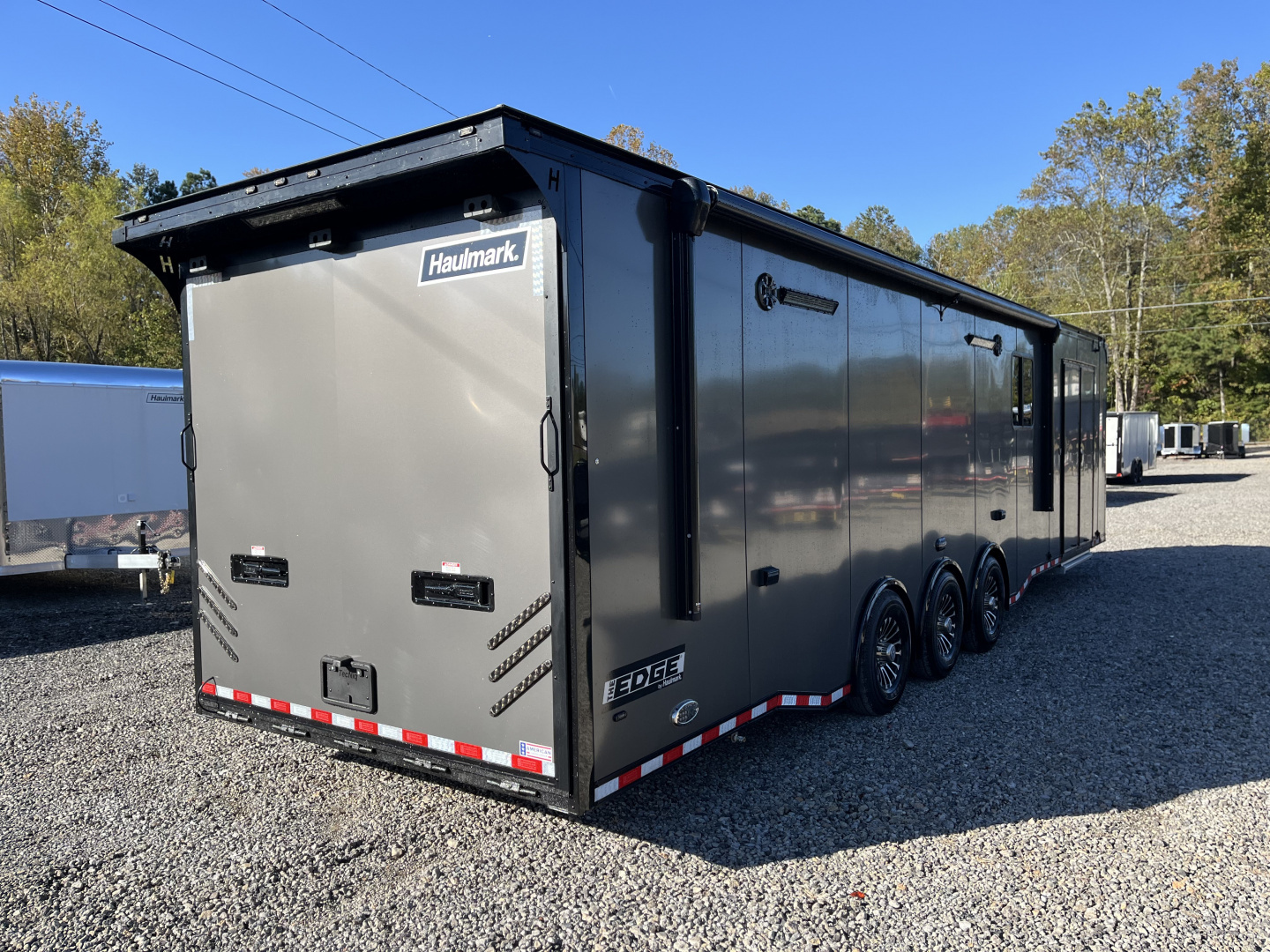 New 2026 Haulmark 34 Bathoom Race Trailer, Air Prep PKG, Awning, Polycor, Insulated, Window, 54" ALX Slide Out Step, A/C + Heat