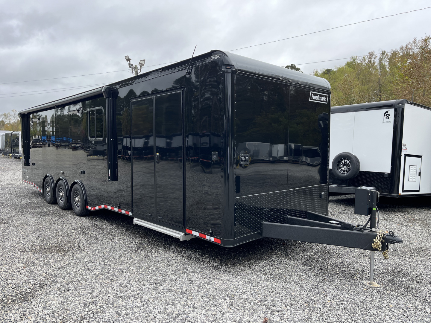 New 2026 Haulmark 34 Bathoom Race Trailer, Air Prep PKG, Awning, Polycor, Insulated, Window, 54" ALX Slide Out Step, A/C + Heat