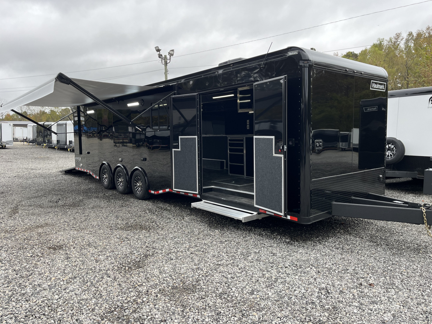 New 2026 Haulmark 34 Bathoom Race Trailer, Air Prep PKG, Awning, Polycor, Insulated, Window, 54" ALX Slide Out Step, A/C + Heat