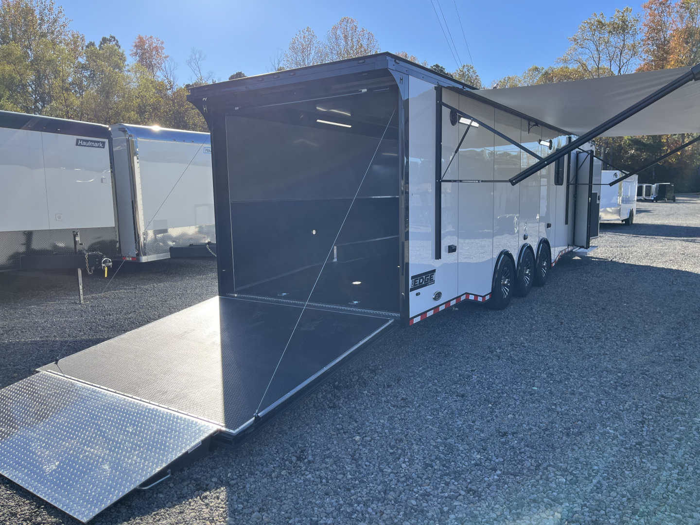 New 2026 Haulmark 34 Bathoom Race Trailer, Air Prep PKG, Awning, Polycor, Insulated, Window, 54" ALX Slide Out Step, A/C + Heat