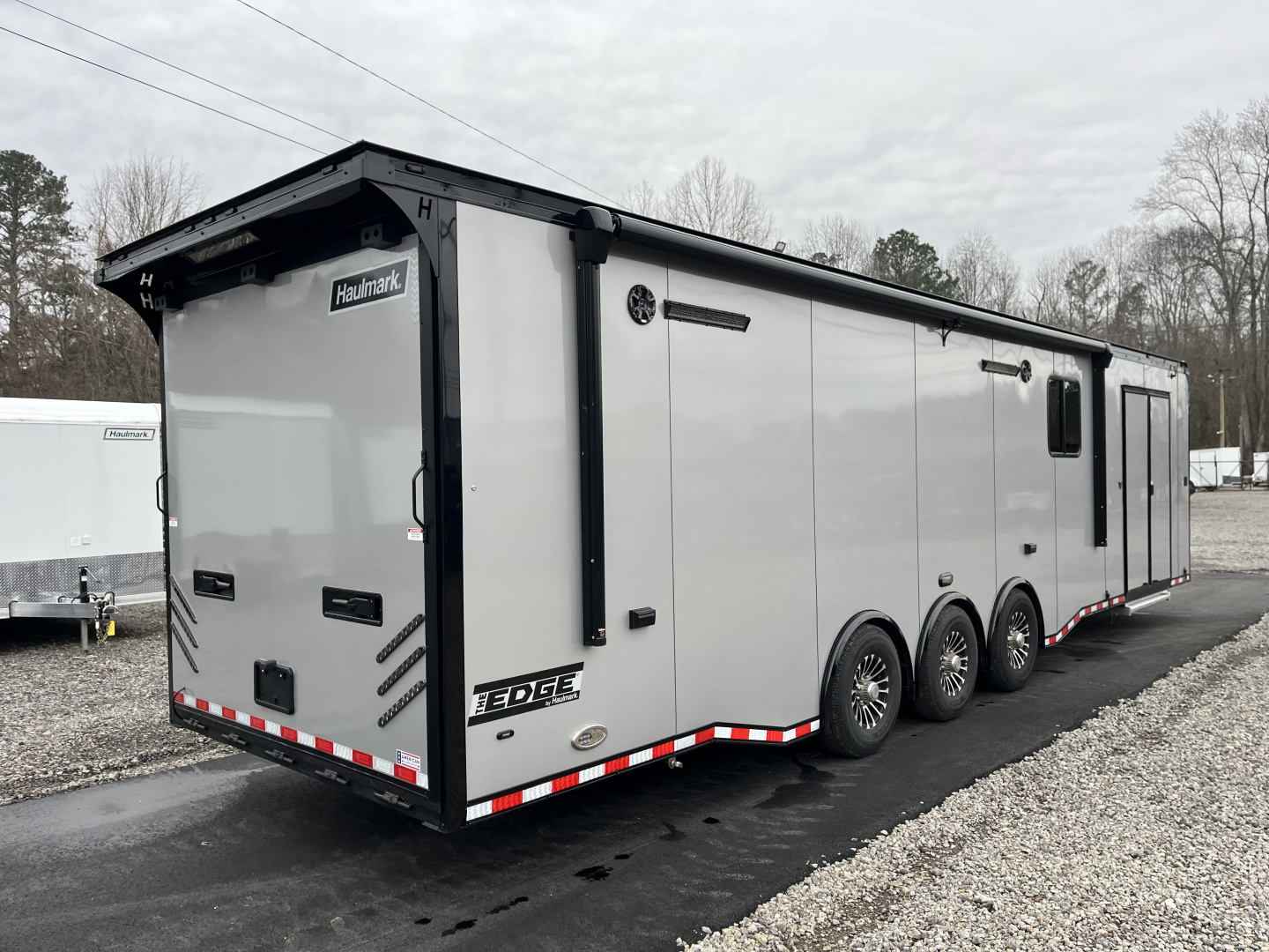 New 2026 Haulmark 34 Bathoom Race Trailer, Air Prep PKG, Awning, Polycor, Insulated, Window, 54" ALX Slide Out Step, A/C + Heat