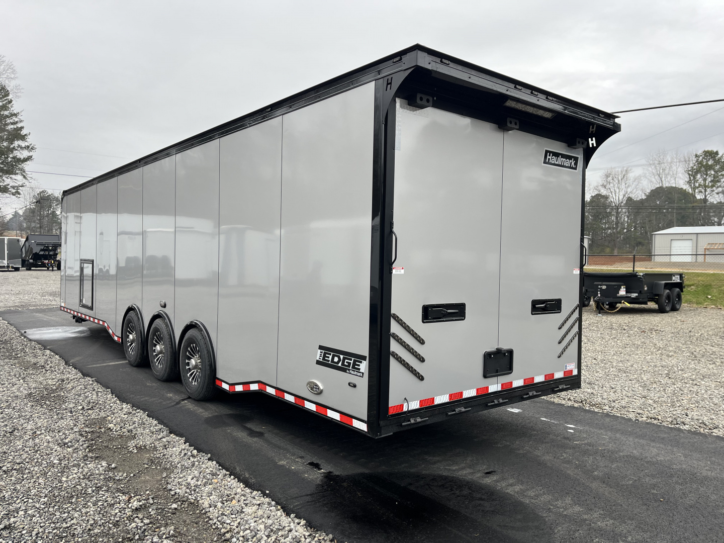 New 2026 Haulmark 34 Bathoom Race Trailer, Air Prep PKG, Awning, Polycor, Insulated, Window, 54" ALX Slide Out Step, A/C + Heat