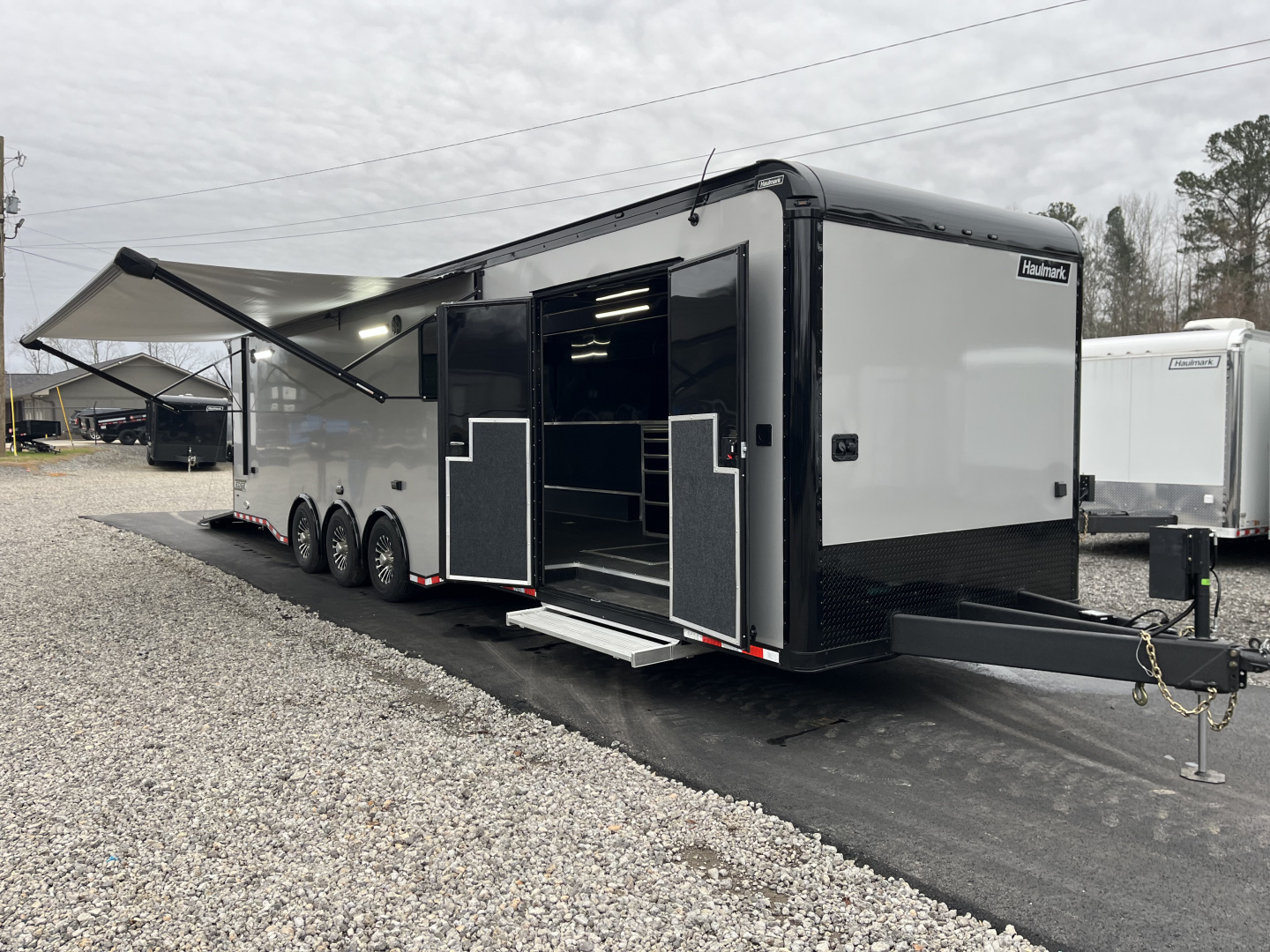 New 2026 Haulmark 34 Bathoom Race Trailer, Air Prep PKG, Awning, Polycor, Insulated, Window, 54" ALX Slide Out Step, A/C + Heat