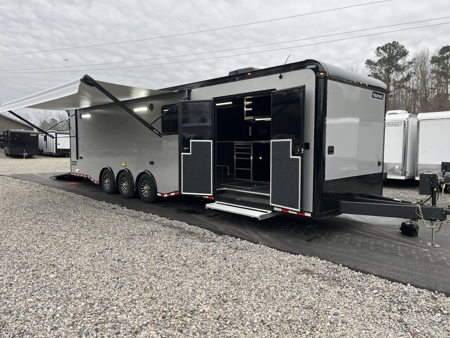 New 2026 Haulmark 34 Bathoom Race Trailer, Air Prep PKG, Awning, Polycor, Insulated, Window, 54" ALX Slide Out Step, A/C + Heat