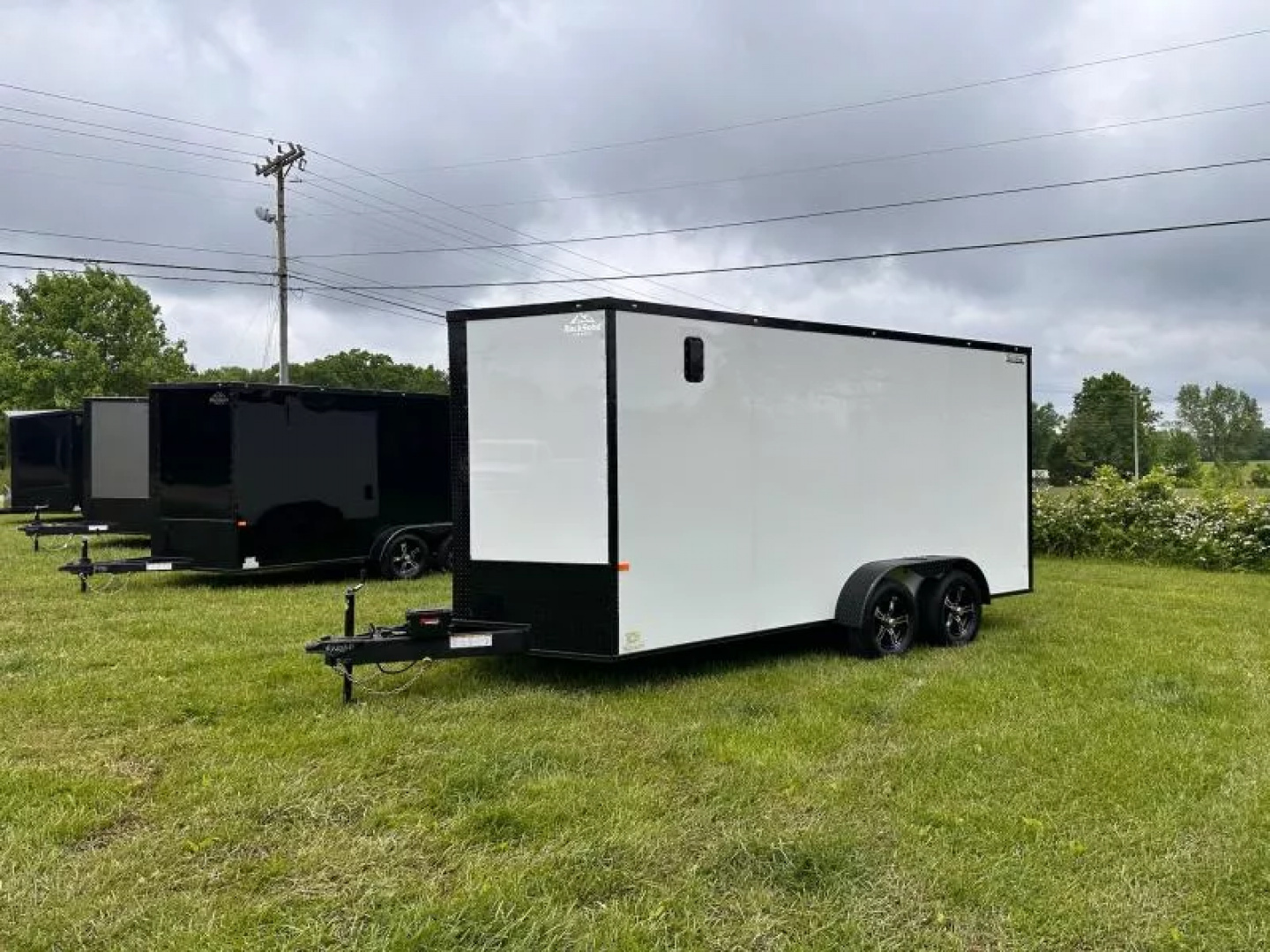 New 2025 Rock Solid Cargo 7X16 Enclosed Trailer-3500LB Tandem Axle-White Poly-Blackout