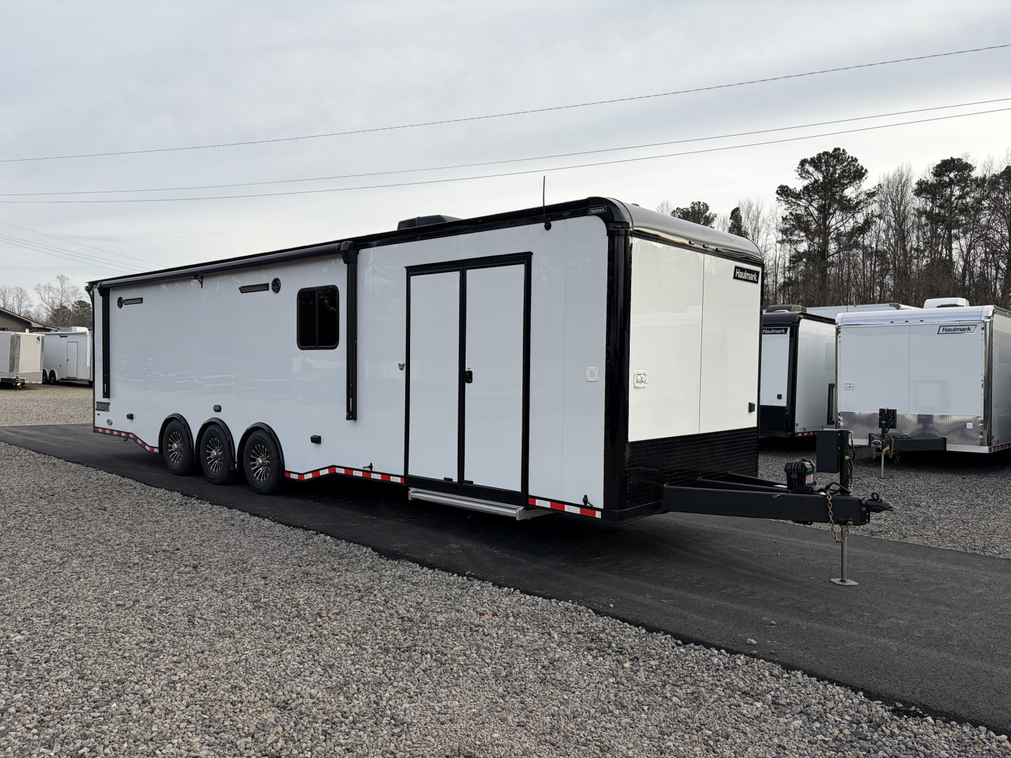 New 2026 Haulmark 34 Bathroom Race Trailer, Air Prep PKG, Awning, Polycor, Insulated, Window, 54" ALX Slide Out Step, A/C + Heat