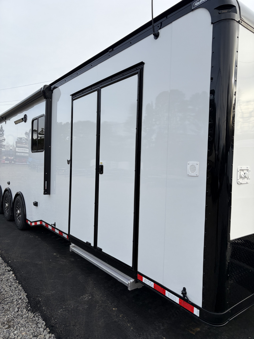 New 2026 Haulmark 34 Bathroom Race Trailer, Air Prep PKG, Awning, Polycor, Insulated, Window, 54" ALX Slide Out Step, A/C + Heat