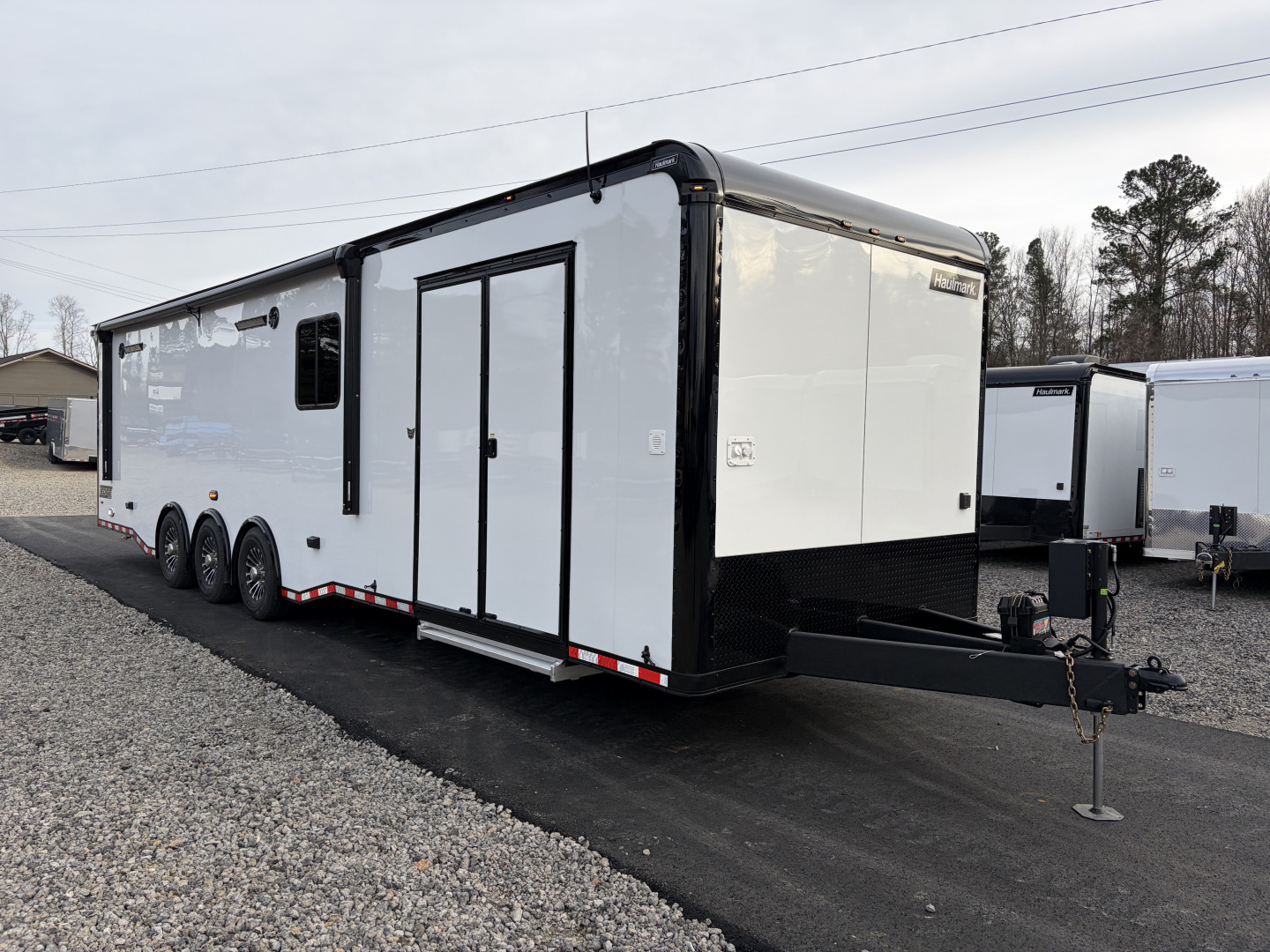 New 2026 Haulmark 34 Bathroom Race Trailer, Air Prep PKG, Awning, Polycor, Insulated, Window, 54" ALX Slide Out Step, A/C + Heat