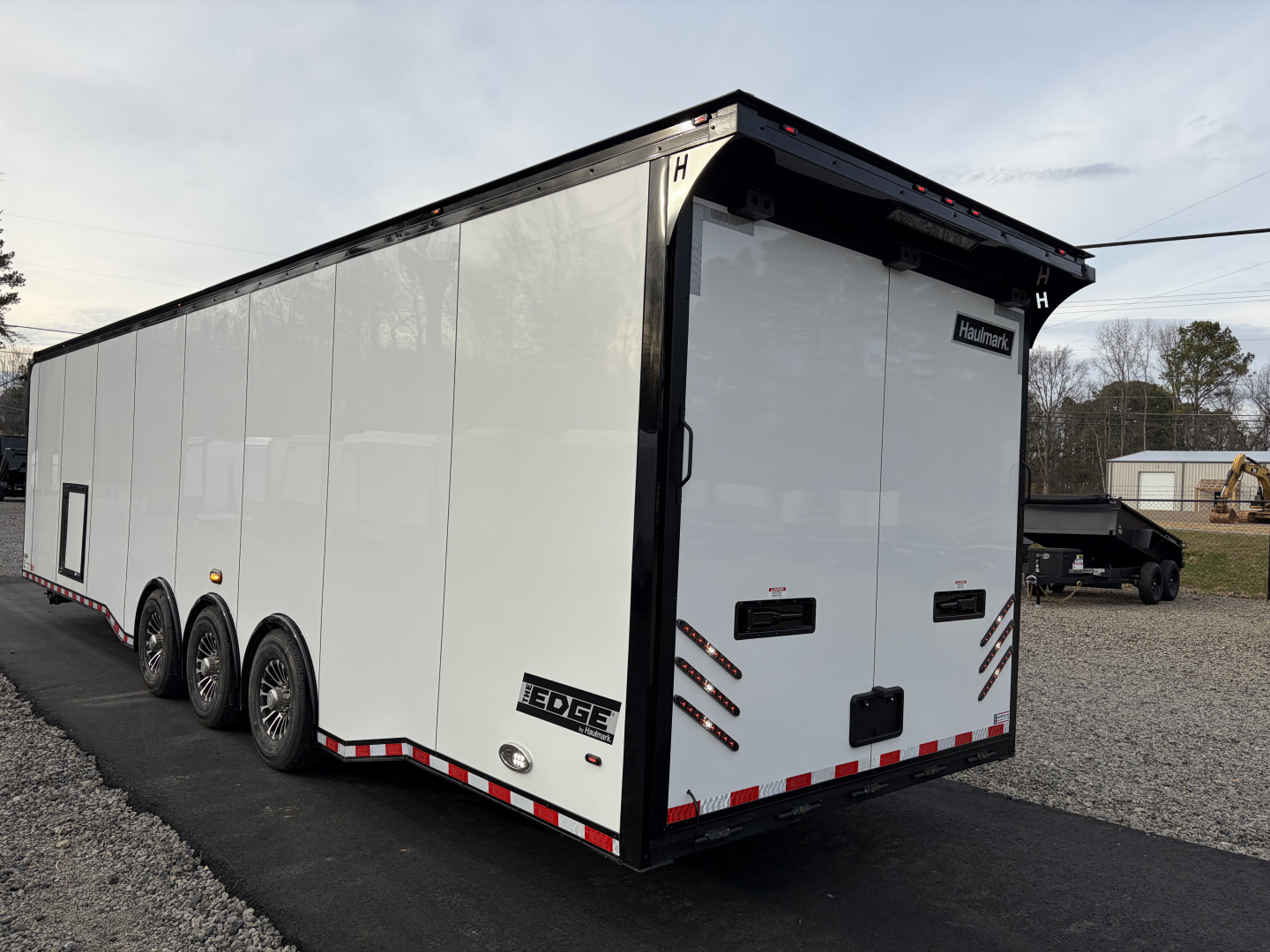 New 2026 Haulmark 34 Bathroom Race Trailer, Air Prep PKG, Awning, Polycor, Insulated, Window, 54" ALX Slide Out Step, A/C + Heat