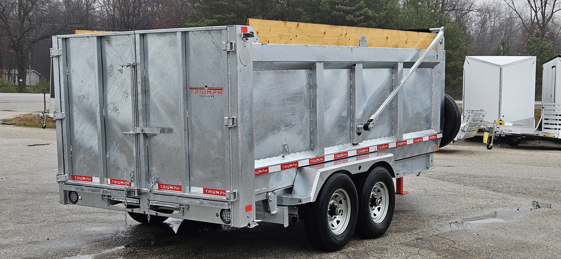 New 82" X 14' GALVANIZED DUMP 7 K AXLES 58" SIDES W/ WOOD RAMP & TARP INCLUDED 2026 TRIUMPH