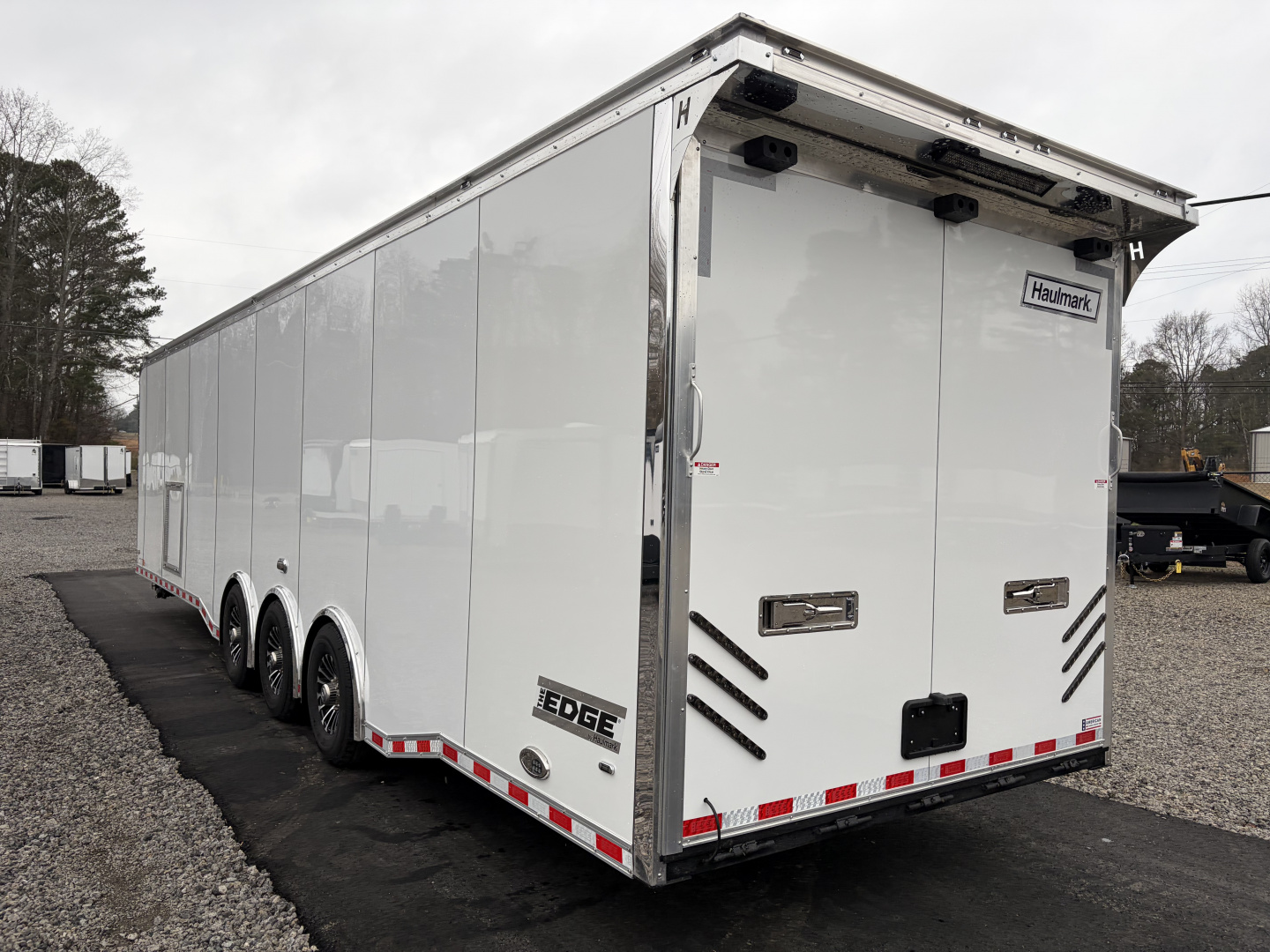 New 2026 Haulmark 34 Bathoom Race Trailer, Air Prep PKG, Awning, Polycor, Insulated, Window, 54" ALX Slide Out Step, A/C + Heat