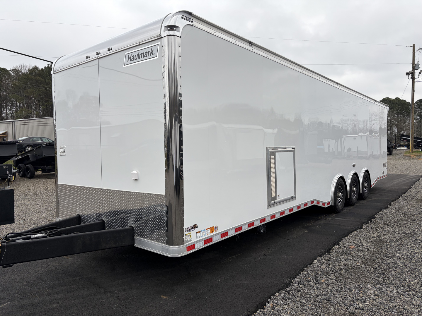 New 2026 Haulmark 34 Bathoom Race Trailer, Air Prep PKG, Awning, Polycor, Insulated, Window, 54" ALX Slide Out Step, A/C + Heat